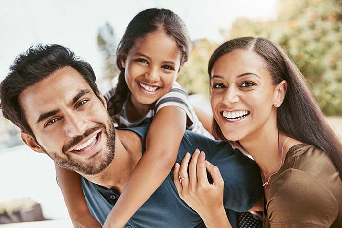 Family of three smiling