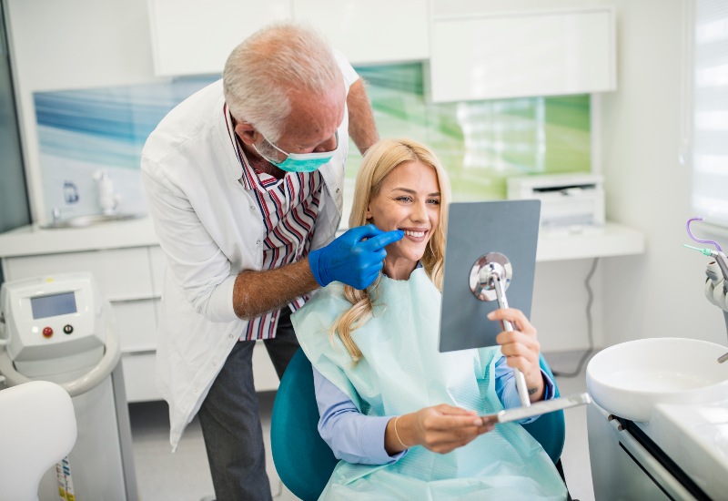 Patient happy after the replacement of missing teeth in St. Charles & Glen Ellyn, IL