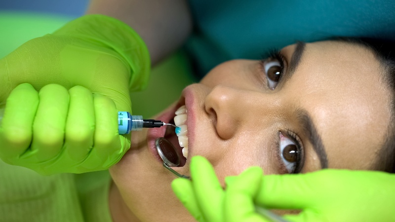 Dentist performing dental bonding treatment in St. Charles & Glen Ellyn, IL