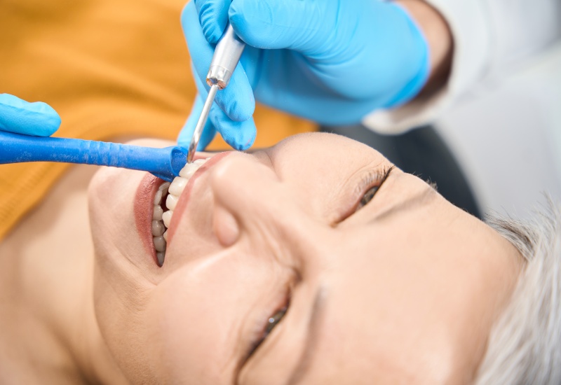 Dentist performing gum contouring treatment in St. Charles & Glen Ellyn, IL