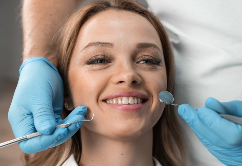 Dentist evaluating smile in St. Charles & Glen Ellyn, IL