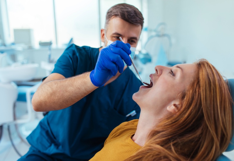 Dentist examining oral thrush procedure in St. Charles & Glen Ellyn, IL