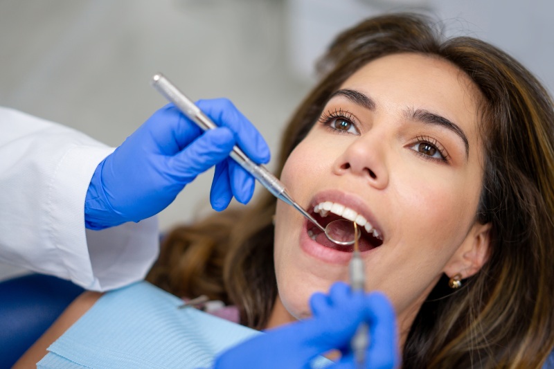 A woman at a dentist's office receives an oral health check in St. Charles & Glen Ellyn, IL