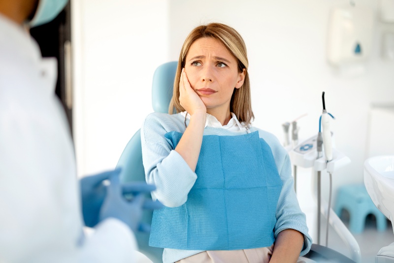 Patient experiencing tooth sensitivity during dental visit in St. Charles & Glen Ellyn, IL