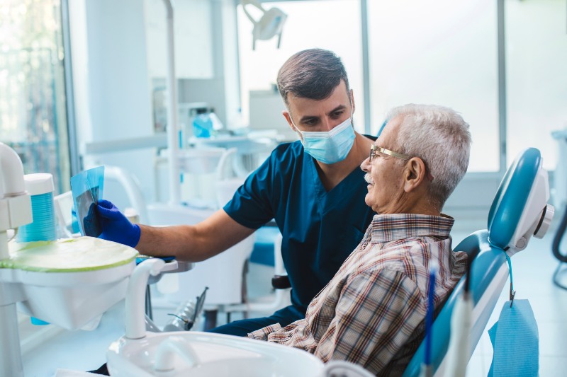 Dentist reviewing dental X-ray with patient in St. Charles and Glen Ellyn, IL