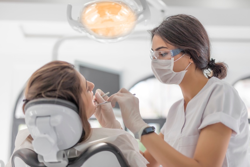 Dentist applying dental sealant during exam in St. Charles and Glen Ellyn, IL